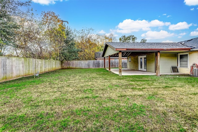 view of yard featuring a patio area and french doors