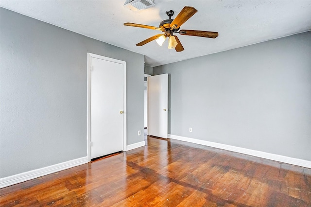 spare room featuring hardwood / wood-style flooring and ceiling fan