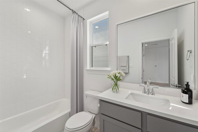 full bathroom featuring vanity, shower / tub combo with curtain, and toilet