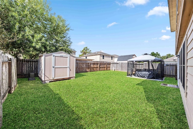 view of yard featuring a gazebo and a storage shed