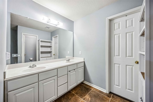 bathroom with vanity and a textured ceiling