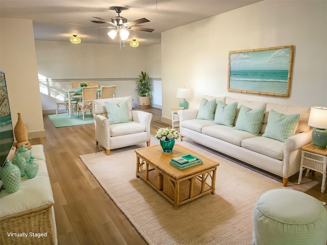 living room with ceiling fan and light hardwood / wood-style floors