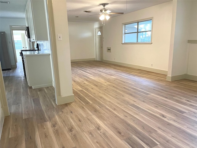 spare room with ceiling fan and light hardwood / wood-style flooring