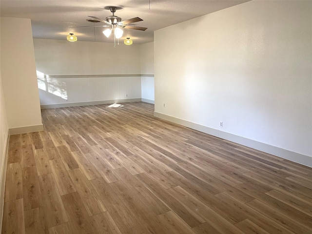 empty room featuring hardwood / wood-style floors and ceiling fan