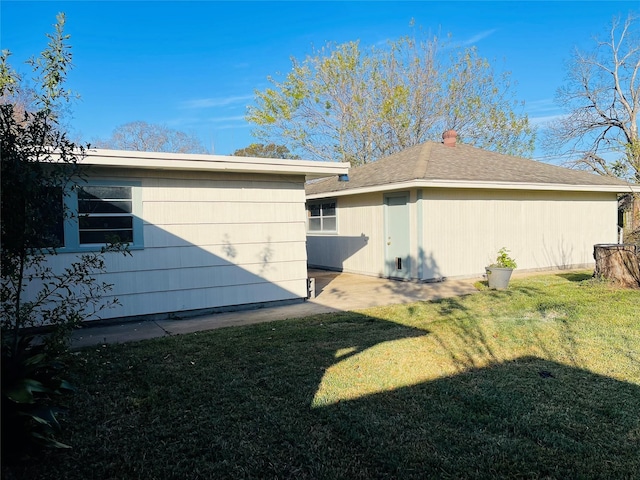 view of home's exterior with a lawn