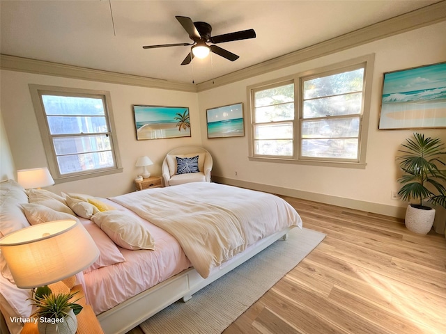 bedroom with ceiling fan, crown molding, and light hardwood / wood-style flooring