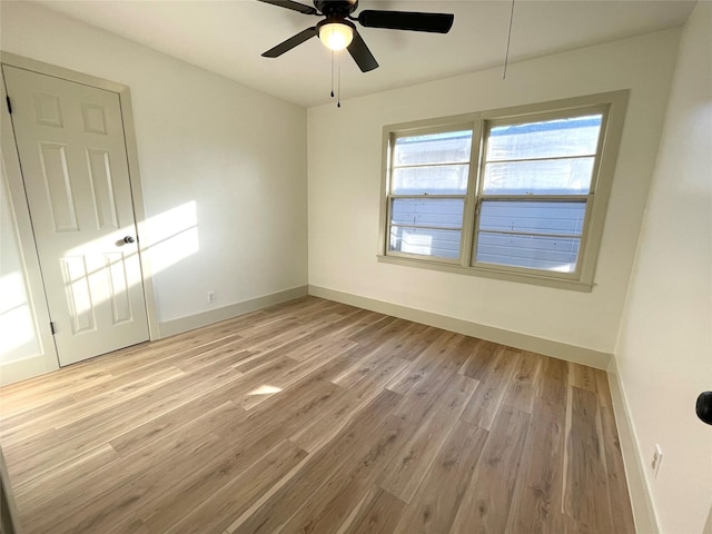 empty room featuring ceiling fan and light hardwood / wood-style flooring