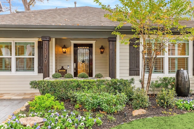 view of exterior entry with a porch