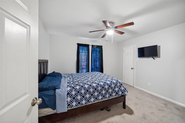 bedroom featuring ceiling fan and light carpet