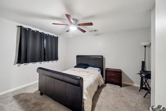 bedroom featuring ceiling fan and light carpet