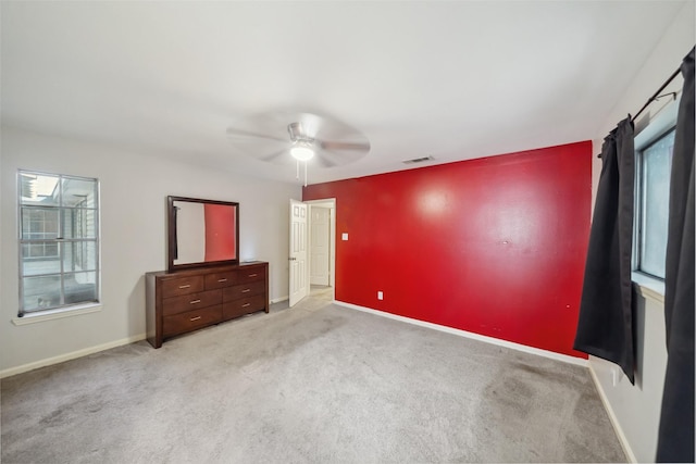 unfurnished bedroom featuring ceiling fan and light carpet