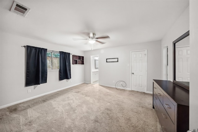 unfurnished bedroom with connected bathroom, light colored carpet, and ceiling fan