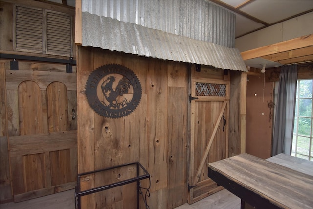 interior details with hardwood / wood-style flooring and wood walls