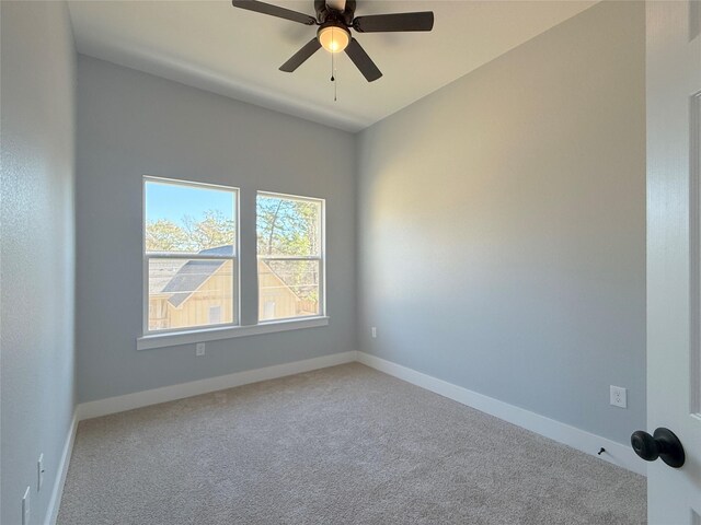 empty room featuring ceiling fan and carpet