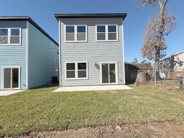 back of property featuring cooling unit, a patio area, and a yard