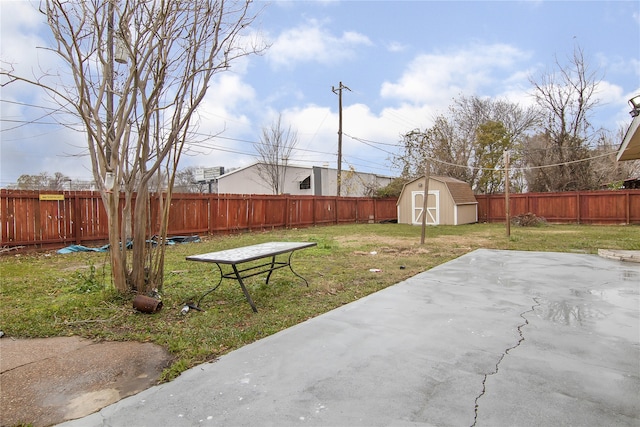 view of yard with a shed and a patio area