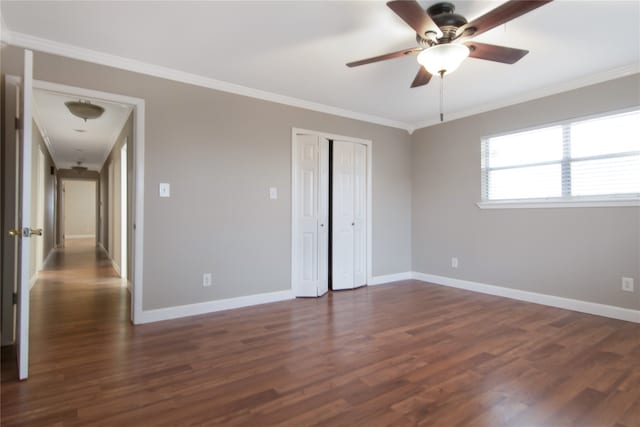 unfurnished bedroom featuring a closet, dark hardwood / wood-style floors, ceiling fan, and ornamental molding