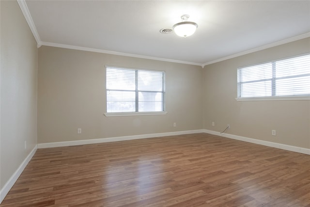 unfurnished room with hardwood / wood-style floors and crown molding