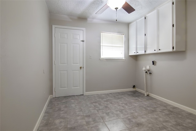 washroom featuring ceiling fan, cabinets, and a textured ceiling