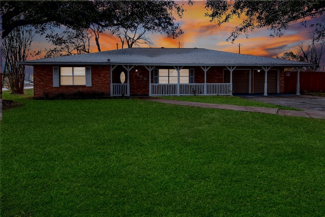 ranch-style home with a lawn