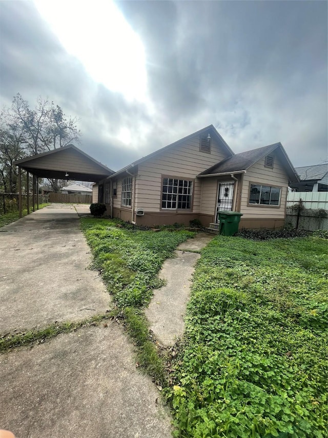 single story home featuring a carport