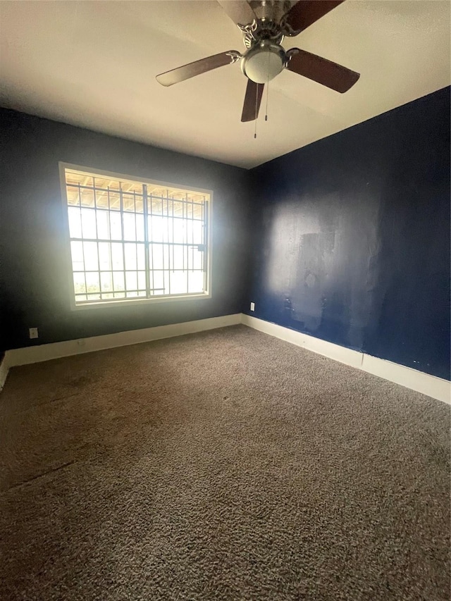 spare room featuring carpet flooring and ceiling fan