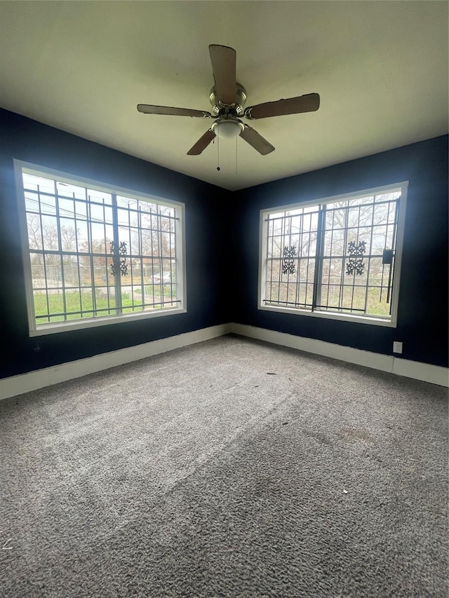 spare room with carpet, ceiling fan, and a healthy amount of sunlight