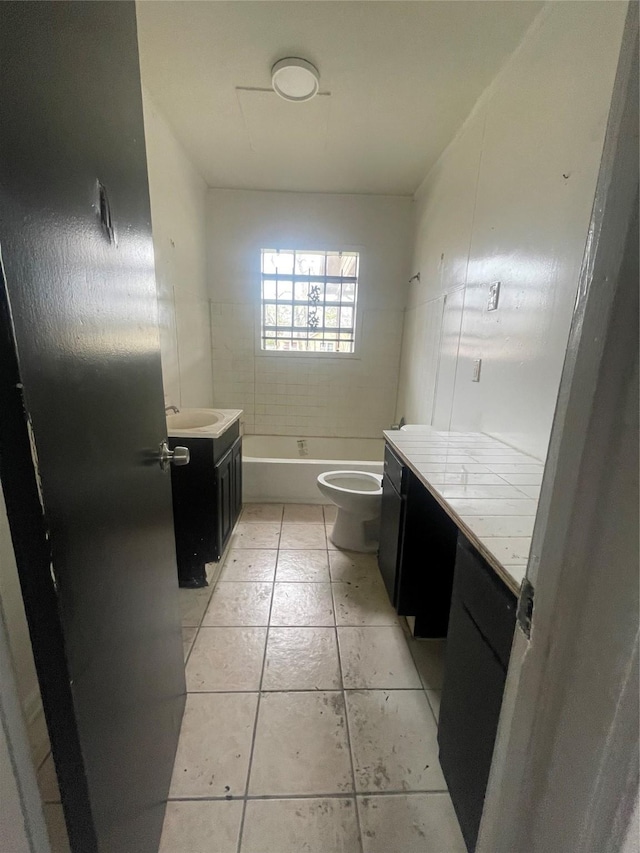 full bathroom featuring tile patterned flooring, vanity, toilet, and tiled shower / bath