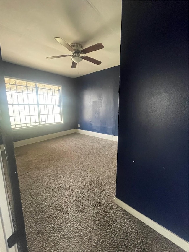 spare room with ceiling fan and carpet floors