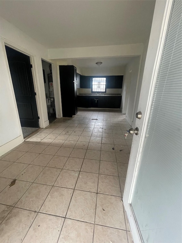 corridor featuring light tile patterned floors