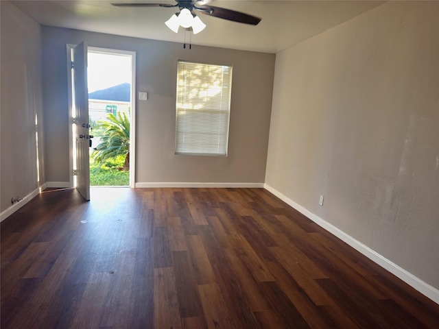 unfurnished room featuring ceiling fan and dark wood-type flooring