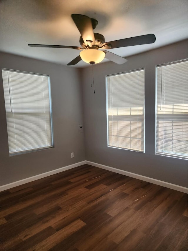 empty room featuring ceiling fan and dark hardwood / wood-style flooring