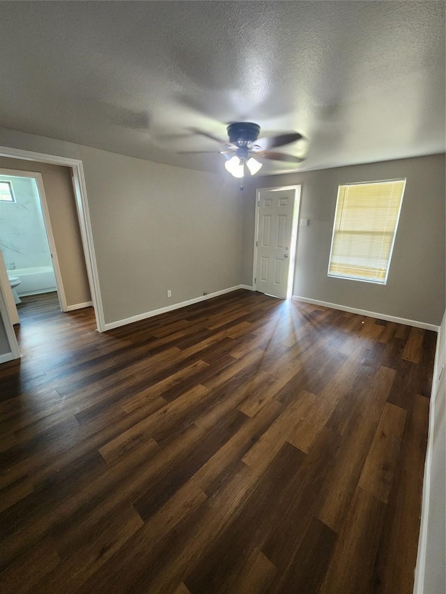 spare room featuring a textured ceiling, dark hardwood / wood-style floors, and ceiling fan