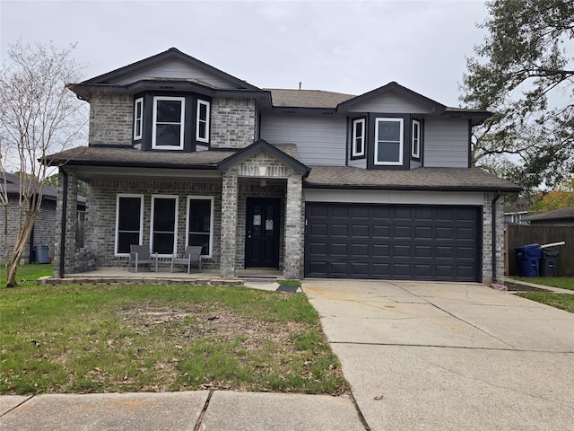 view of front of house with covered porch, a front yard, and a garage