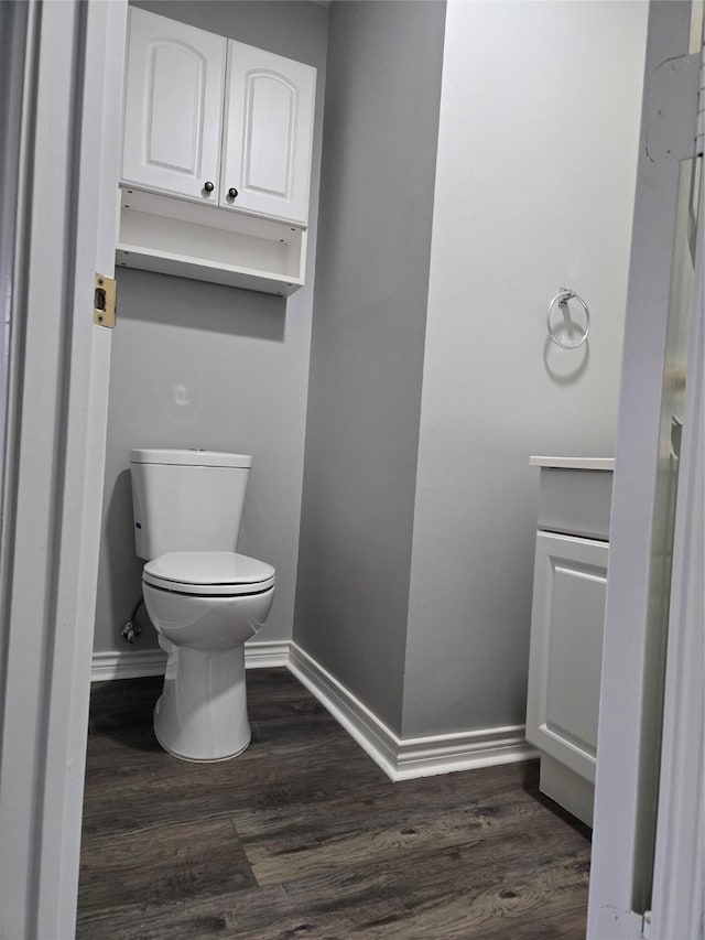 bathroom featuring hardwood / wood-style floors, vanity, and toilet