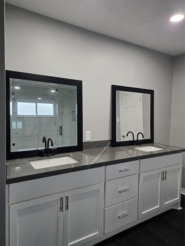 bathroom with vanity and a shower with shower door