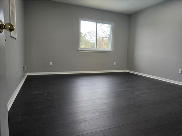 empty room featuring dark wood-type flooring