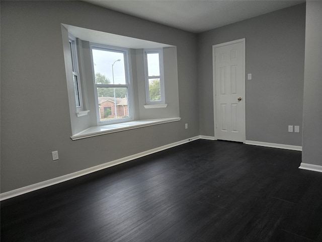 empty room with dark hardwood / wood-style floors