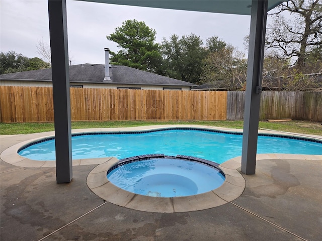 view of swimming pool featuring an in ground hot tub