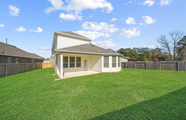 rear view of house with a patio area and a lawn