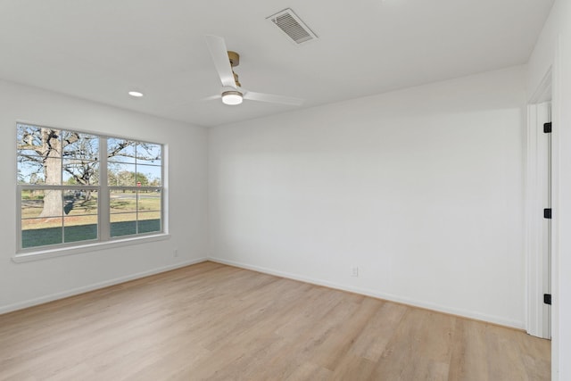 empty room featuring ceiling fan and light hardwood / wood-style floors