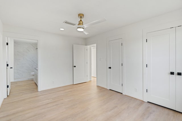 unfurnished bedroom with ceiling fan, light wood-type flooring, and connected bathroom