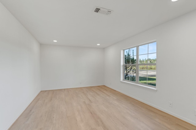 spare room with light hardwood / wood-style flooring