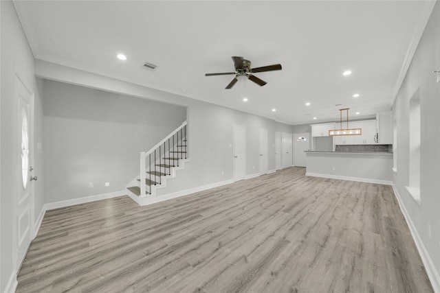 unfurnished living room with ceiling fan, light wood-type flooring, and ornamental molding