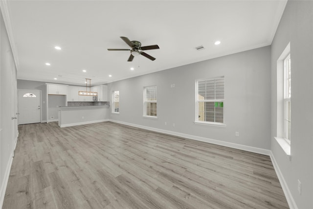 unfurnished living room with ceiling fan and light hardwood / wood-style floors