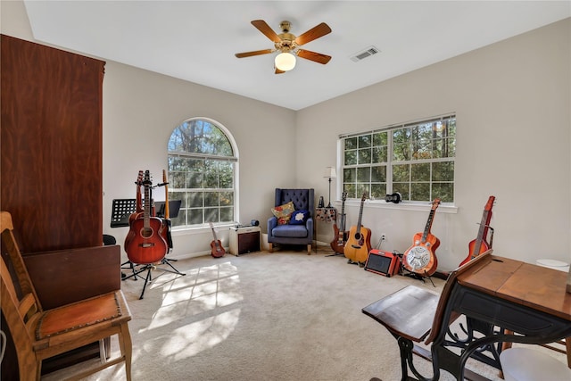 sitting room featuring light carpet and ceiling fan