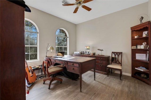 home office featuring wood-type flooring, plenty of natural light, and ceiling fan