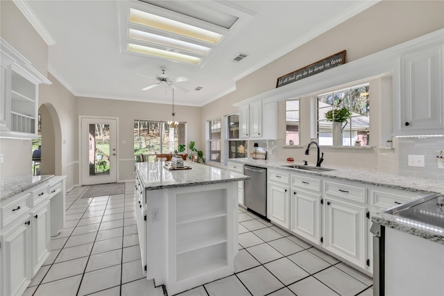 kitchen with white cabinets, dishwasher, a kitchen island, and sink