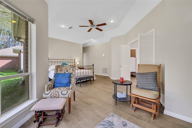 living area with ceiling fan and light wood-type flooring