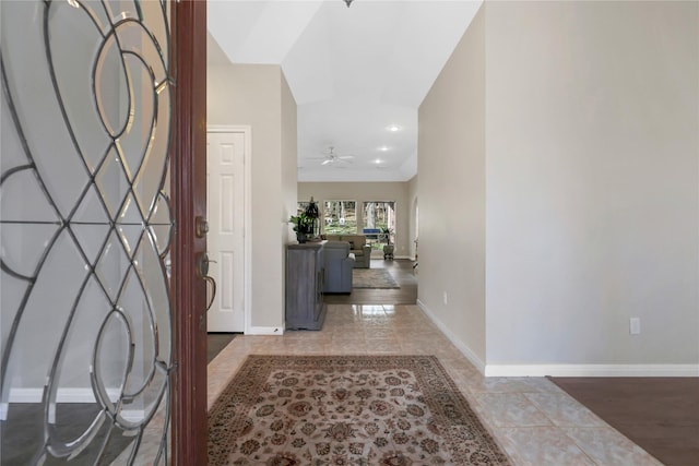 foyer entrance featuring ceiling fan